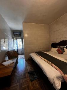 a bedroom with two beds and a wooden floor at Mayadeep Resort and Hostels in Chopta +19 photos