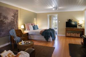 a bedroom with a bed and a tv in a room at Avalon in Hepburn Springs