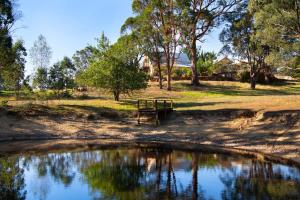 a picnic table next to a body of water at Avalon in Hepburn Springs