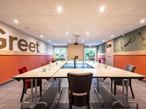 a large meeting room with tables and chairs in it at greet Hotel Massieux Lyon Nord by All Accor in Massieux