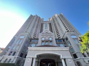 a tall white building with a gate in front of it at Grand Dafam Ancol Jakarta in Jakarta