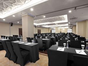a room full of tables and chairs with wine glasses at Grand Dafam Ancol Jakarta in Jakarta +69 photos