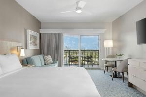 a hotel room with a white bed and a table and chairs at Marriott Beachplace Towers 2BD in Fort Lauderdale +38 photos