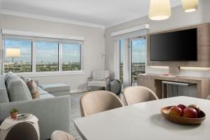 a living room with a couch and a tv at Marriott Beachplace Towers 2BD in Fort Lauderdale