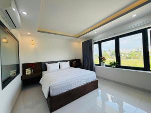 a bedroom with a bed and a large window at Hotel Trâm Anh 3 in Nhơn Trạch +20 photos