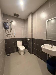 a bathroom with a toilet and a sink at TT Dorf Hotel Taiping in Taiping