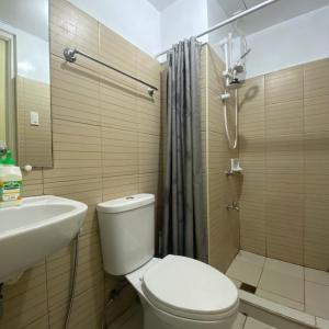 a bathroom with a toilet and a sink and a shower at MGs Dwell - Baguio Transient at Moldex Residences in Baguio +12 photos