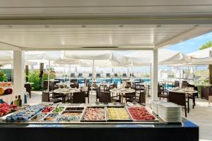 a buffet line with food on a restaurant at Hotel Byron Bellavista in Lido di Jesolo