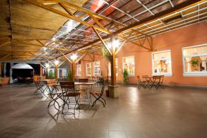a large room with chairs and tables in it at Filo Hotel in Gheorgheni