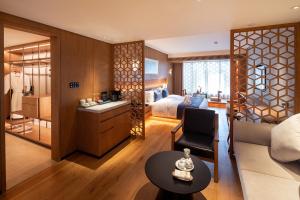 a hotel room with a bed and a living room at The Lantern in Shunde