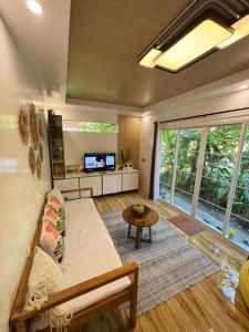 a living room with a couch and a table at KAMURAYAW SIARGAO in General Luna