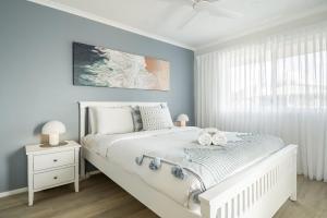 a bedroom with a white bed and a window at Apartment 9T in Lennox Head