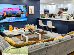 a living room with two couches and a large tv at Miramar Retreat Arcade Game Room King Bed 25 Min to Hollywood Beach in Miramar