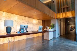 a lobby with a desk with two laptops on it at The Lantern in Shunde