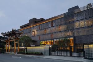 a building with a fence in front of it at The Lantern in Shunde