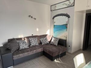 a living room with a couch with pillows on it at Amicizia in Valledoria