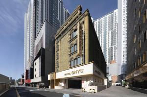 a building with a sign on the front of it at Hotel ONYU Busan Sasang in Busan