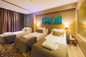 Uma cama ou camas num quarto em Doğa Thermal Health & Spa
