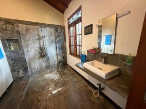 a bathroom with a sink and a shower at Angelica Villa in Bentota +58 photos