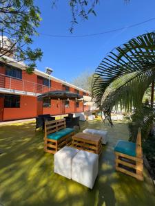a building with benches and tables in front of it at Hospedaje Los Pecanos in Ica