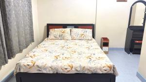a bedroom with a bed with a white comforter at Collection O Southern Star Resort Pattaya in North Pattaya
