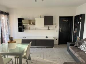a living room with a couch and a table at Amicizia in Valledoria +19 photos