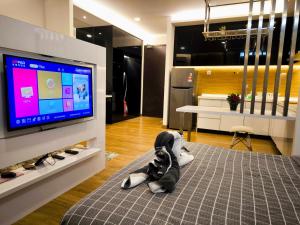 a room with a television and a stuffed animal on the floor at Eshue Designer Suites @ Simfoni Towers in Cheras +41 photos