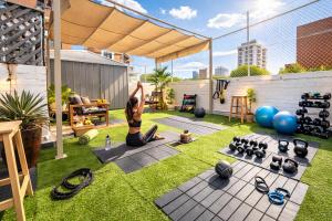 a woman doing a yoga pose on the grass at Tequila Sunrise Potts Point in Sydney