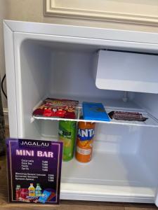 an open refrigerator with food and drinks in it at Jagalau in Balqash