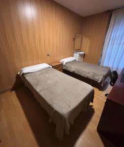 a room with two beds in a room at Hostal San Juan Oyarbide Tolosa in Tolosa
