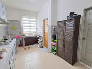 a kitchen with a large cabinet with shelves in it at Homestay nakhoda Sitiawan in Lumut