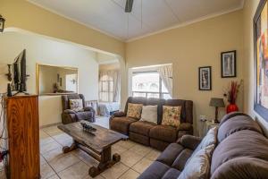a living room with a couch and a table at Cabanas Del Mar 76 By Evermore in Kingsborough
