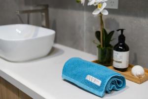 a bathroom counter with a bottle of wine and a towel at Beachfront Bliss Luxury Views in Rye +15 photos