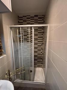 a shower with a glass door in a bathroom at Hostal San Juan Oyarbide Tolosa in Tolosa