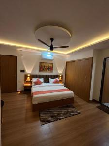 a bedroom with a large bed and a ceiling fan at Hotel Chunda Niwas in Dabok