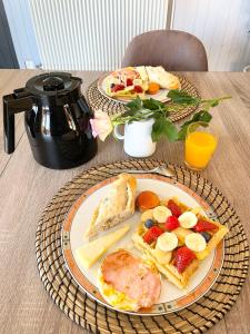 a table with two plates of breakfast food on it at L'Océane Bed&Breakfast in Lacanau-Océan +28 photos