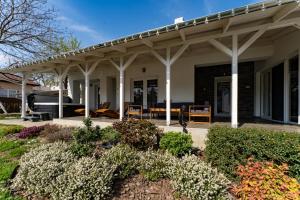 a house with a patio with a roof at Boutique Villa Gyula in Gyula