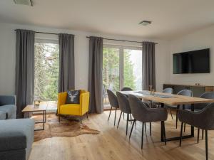a living room with a dining room table and chairs at Chalet in Turracher Höhe with Ski Slope Access in Turracher Hohe +40 photos