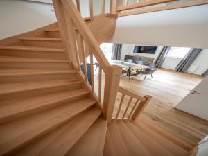 a wooden staircase in a room with a table at Chalet in Turracher Höhe with Ski Slope Access in Turracher Hohe