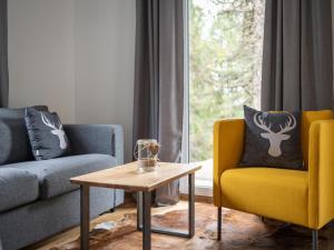 a living room with two chairs and a coffee table at Chalet in Turracher Höhe with Ski Slope Access in Turracher Hohe