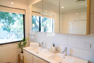 a bathroom with a sink and a mirror at Amity Treetops - Prime Location - Sleeps 7 in Amity Point +26 photos