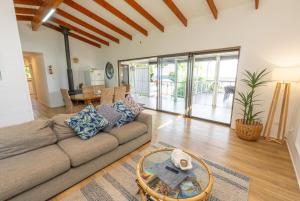 a living room with a couch and a table at Amity Treetops - Prime Location - Sleeps 7 in Amity Point