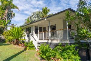 a house with palm trees in front of it at Amity Treetops - Prime Location - Sleeps 7 in Amity Point