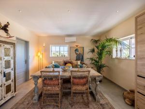 a dining room with a table and chairs at Nice Villa in Budens with pool in Budens
