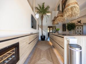 a hallway with wooden counters and a palm tree at Nice Villa in Budens with pool in Budens