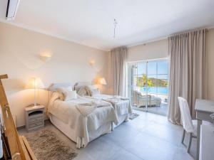a bedroom with a bed and a view of the ocean at Nice Villa in Budens with pool in Budens