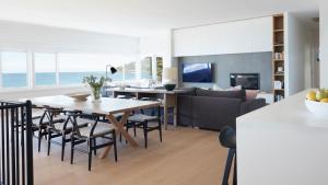 a kitchen and living room with a table and chairs at The Palms in Palm Beach