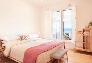 a bedroom with a bed and a large window at The Palms in Palm Beach