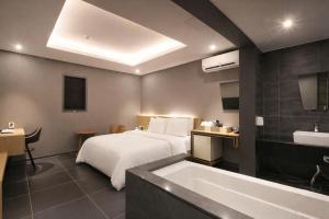 a hotel room with a bed and a bath tub at Zenith Hotel Bupyeong in Incheon +45 photos