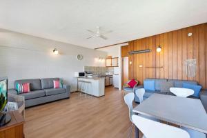 a living room with a couch and a table at The Sands Apartment 6 in The Entrance